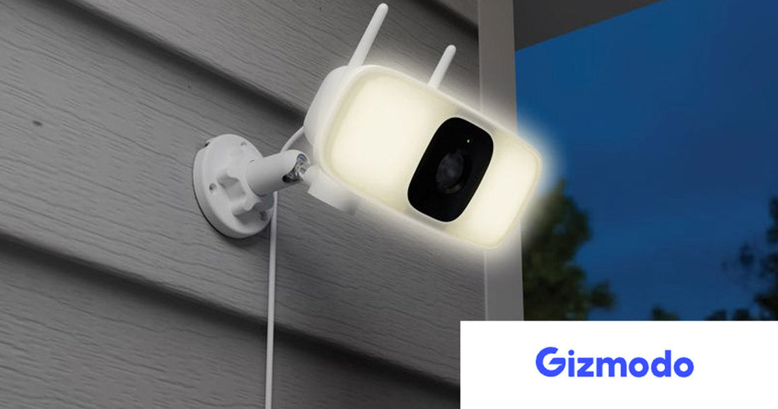 Lorex Connect 2K Floodlight Security Camera mounted outdoors on home siding at dusk, with built-in LED floodlight illuminated and dual antennas visible, highlighting AI-powered outdoor protection.