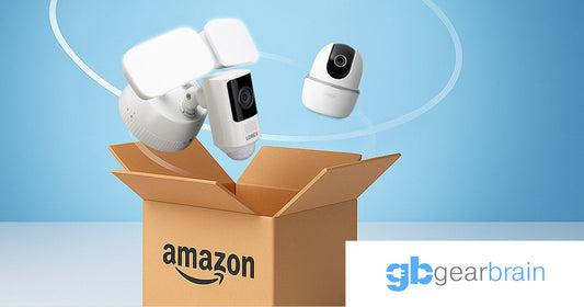 Lorex security cameras, including floodlight, video doorbell, and indoor pan-tilt models, emerging from an Amazon Prime delivery box, featured in Gearbrain’s Prime Day coverage.