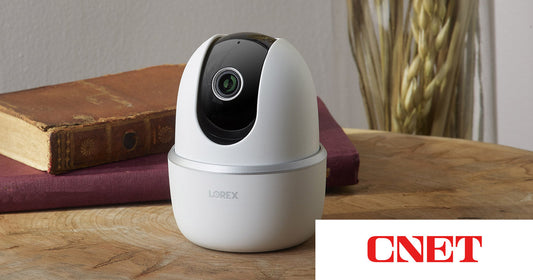 Lorex 2K Pan and Tilt Indoor Wi-Fi Camera placed on a wooden table, featured in CNET’s Prime Day 2025 coverage of indoor security camera deals.
