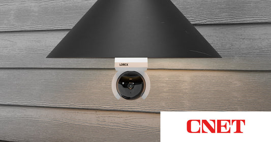 Lorex Connect Smart Lightbulb Camera installed in an outdoor light fixture, featured in CNET.
