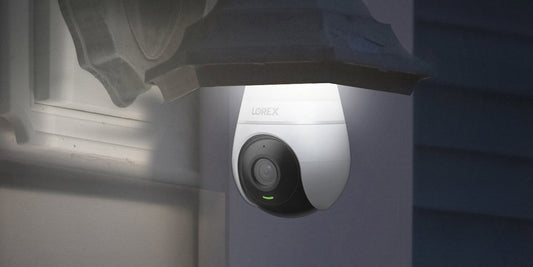Lorex lightbulb security camera installed under an outdoor light fixture, providing discreet home surveillance with a built-in LED light.
