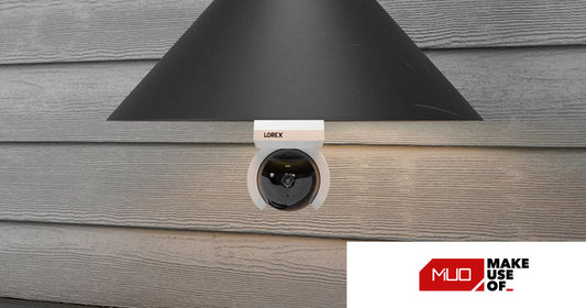 Lorex Connect 2K Wi-Fi Smart Lightbulb Pan-Tilt Camera installed in an outdoor light fixture under a wall lamp, providing wide-area security monitoring with 360° coverage.