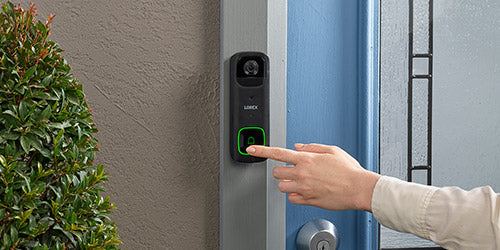 Finger pressing Lorex 2K Battery Video Doorbell