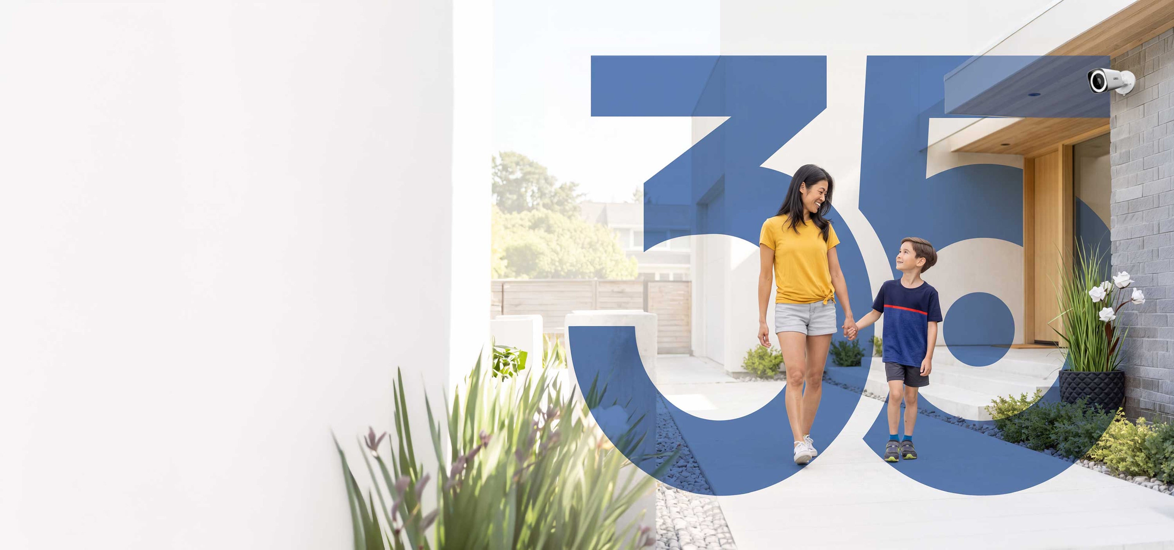 Mother and child walking outside a home with Lorex security camera and large 35 graphic celebrating Lorex’s 35th anniversary