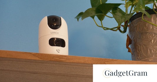 Lorex Connect 2K Dual-Lens Indoor Camera displayed on a shelf beside a potted plant, featured in GadgetGram's review of its smart indoor monitoring capabilities.