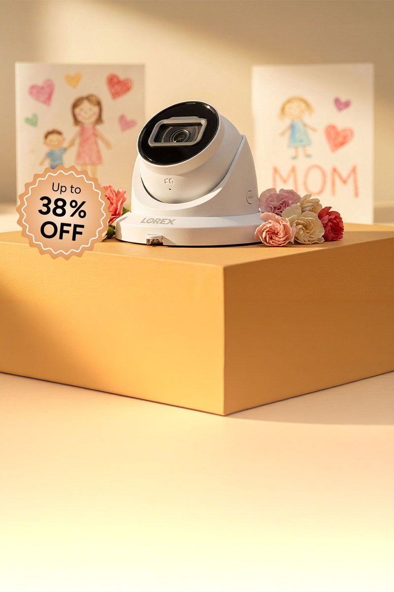 Lorex indoor security camera displayed with flowers and Mother’s Day cards, promoting sale with up to 38% off