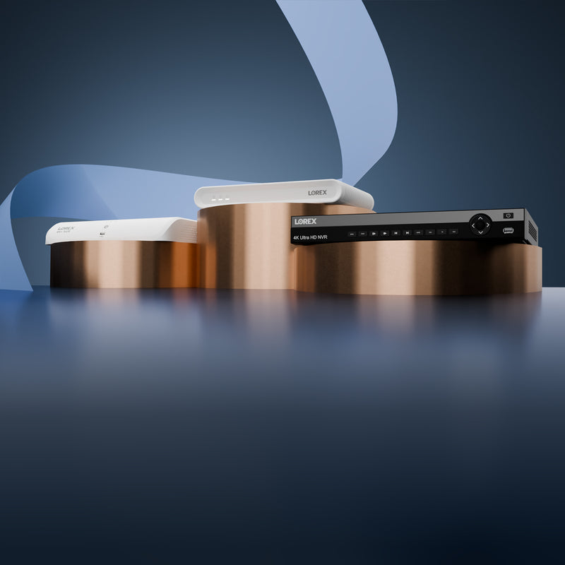 Lorex NVR and DVR security recorders displayed on round bronze pedestals with a blue abstract background