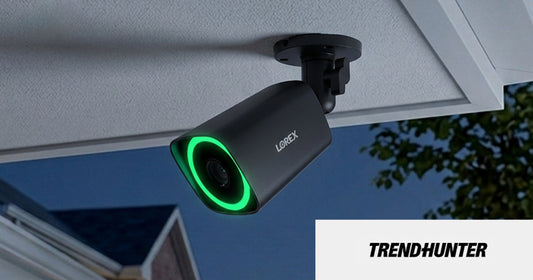 Lorex V7 4K PoE bullet camera mounted under an eave at night with green Smart Security Lighting, featured in Trend Hunter.