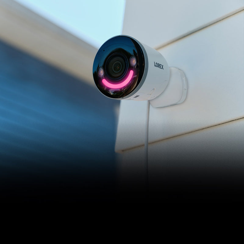 Wireless (Wi-Fi) Security Camera on exterior house wall with pink Smart Security Lighting